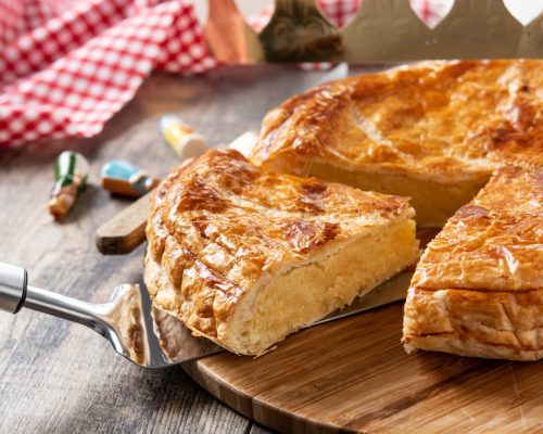 Galette des rois on wooden table. Traditional Epiphany cake in France